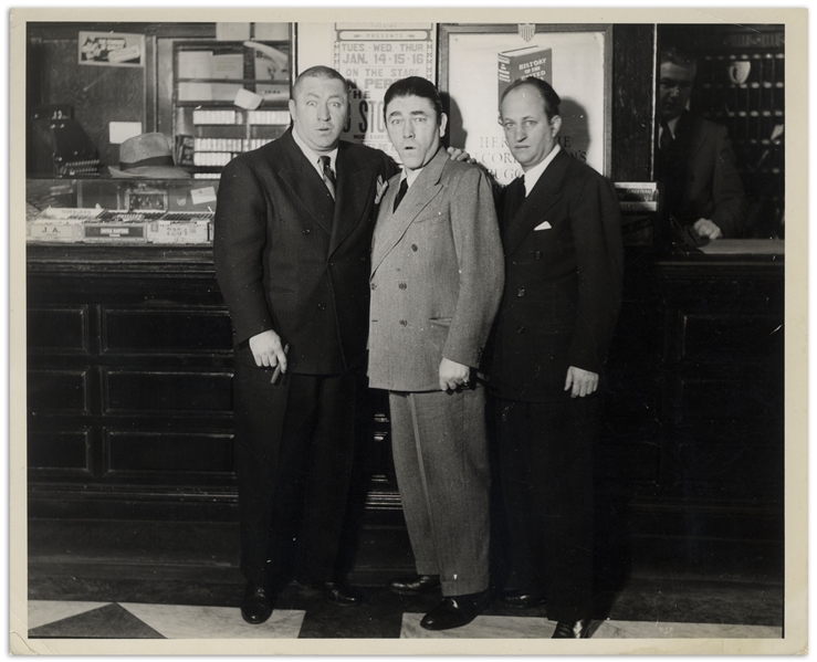 10 x 8 Glossy Photo From 1939, Featuring Curly, Moe & Larry Standing in Front of a 3 Stooges Poster -- Label on Verso Reads on tour in Fallriver, Mass. -- Double-Weight Photo Is Very Good